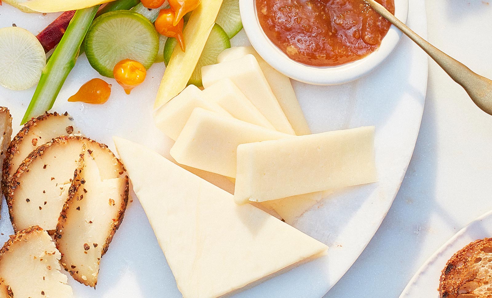 Five sliced pieces of premium gouda cheese.