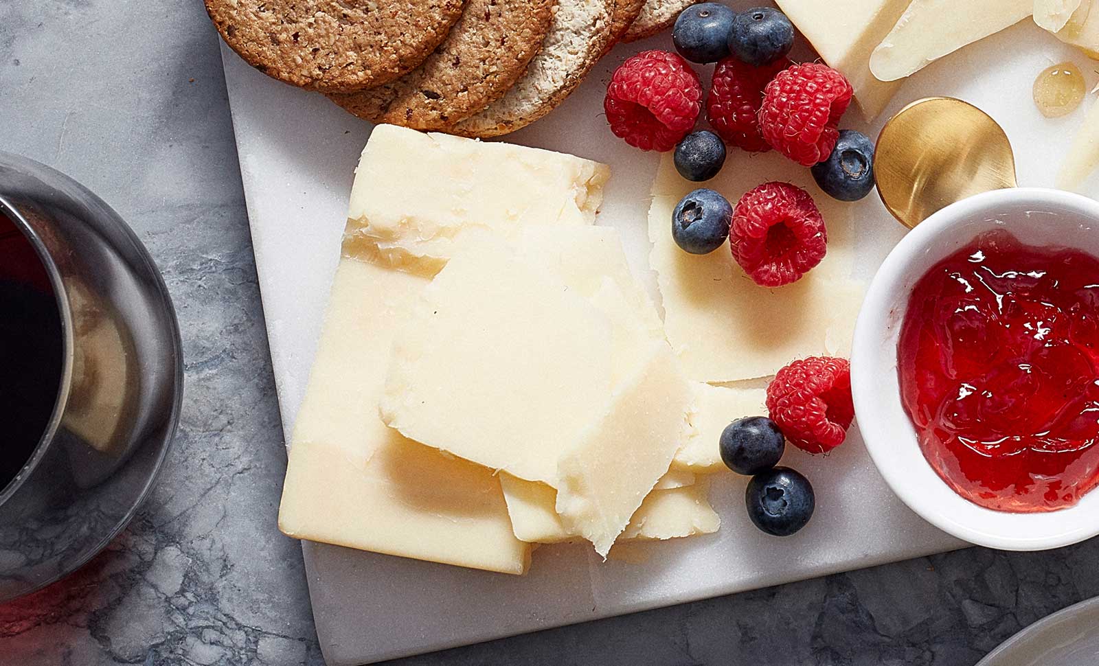 Three-year aged cheddar plated with raspberries, blueberries and jam.