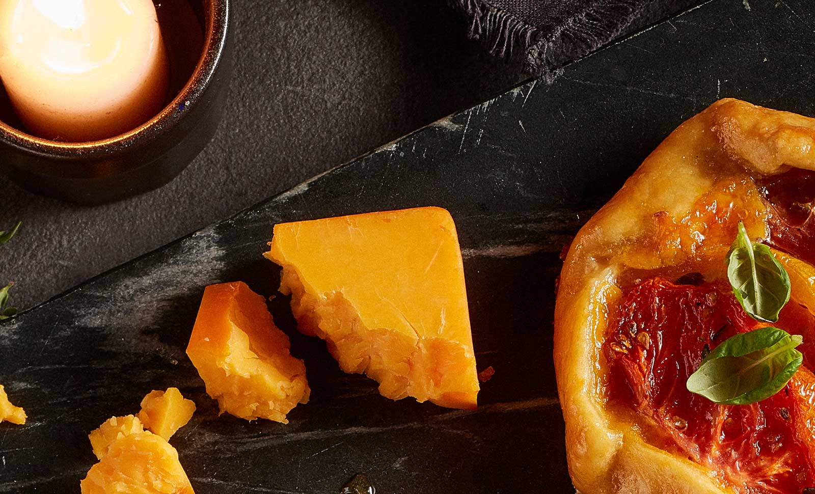 Two pieces of artisan smoked cheddar cheese.