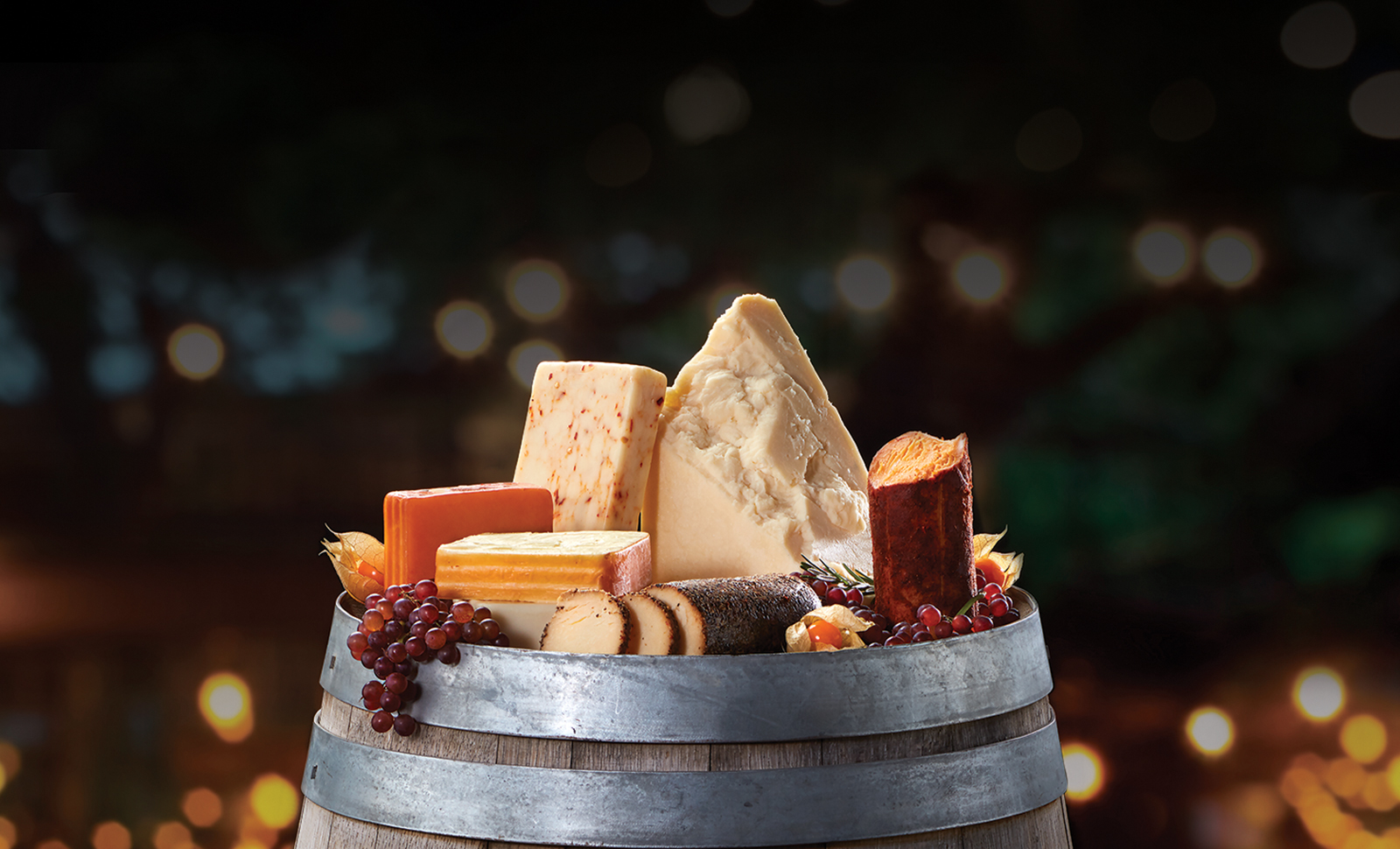 Assorted artisan, log and naturally smoked cheeses in the top of a wine barrel.