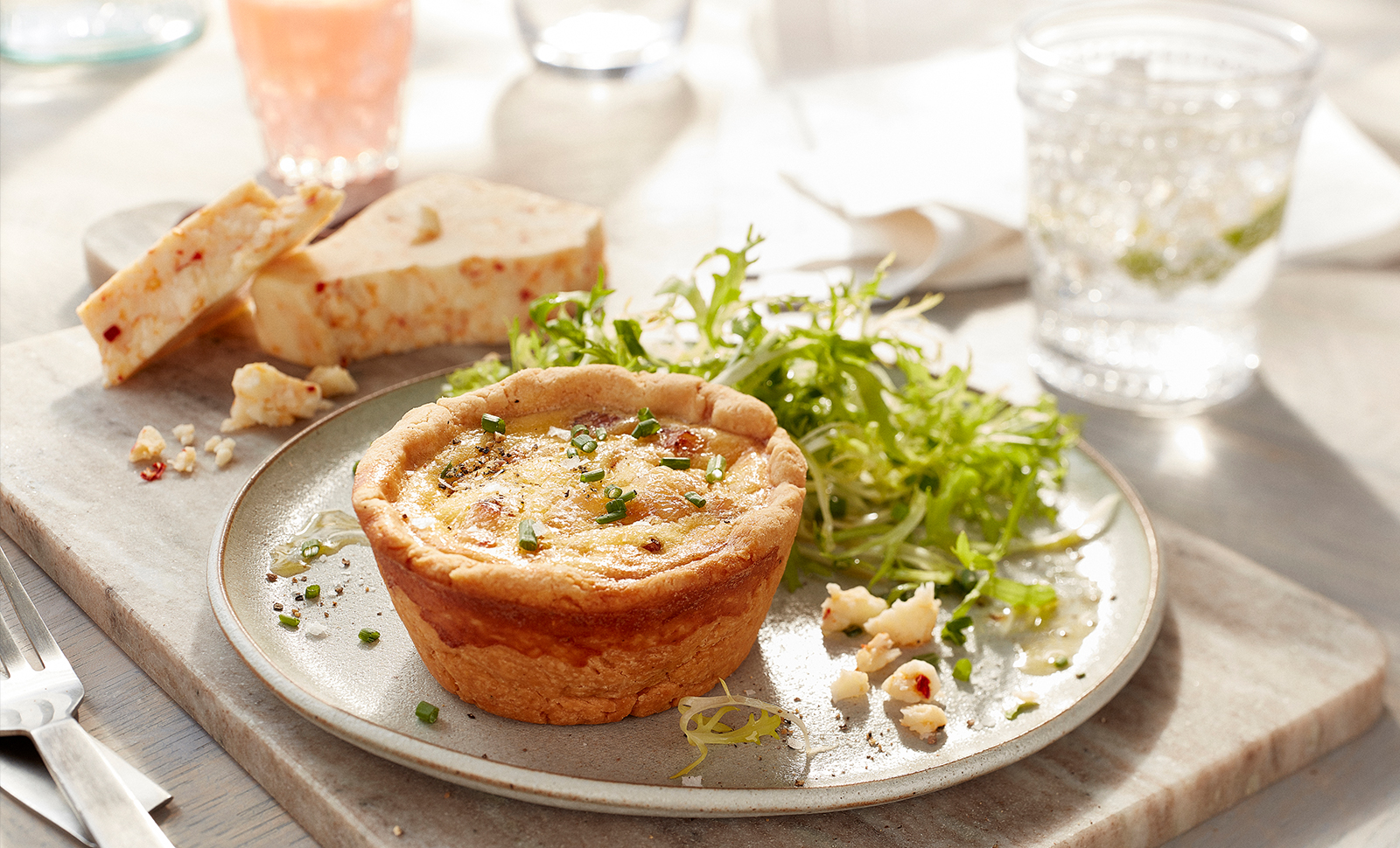 Mini ham cheese quiche served with a small garden salad with Monterey pepper jack cheese on the side.